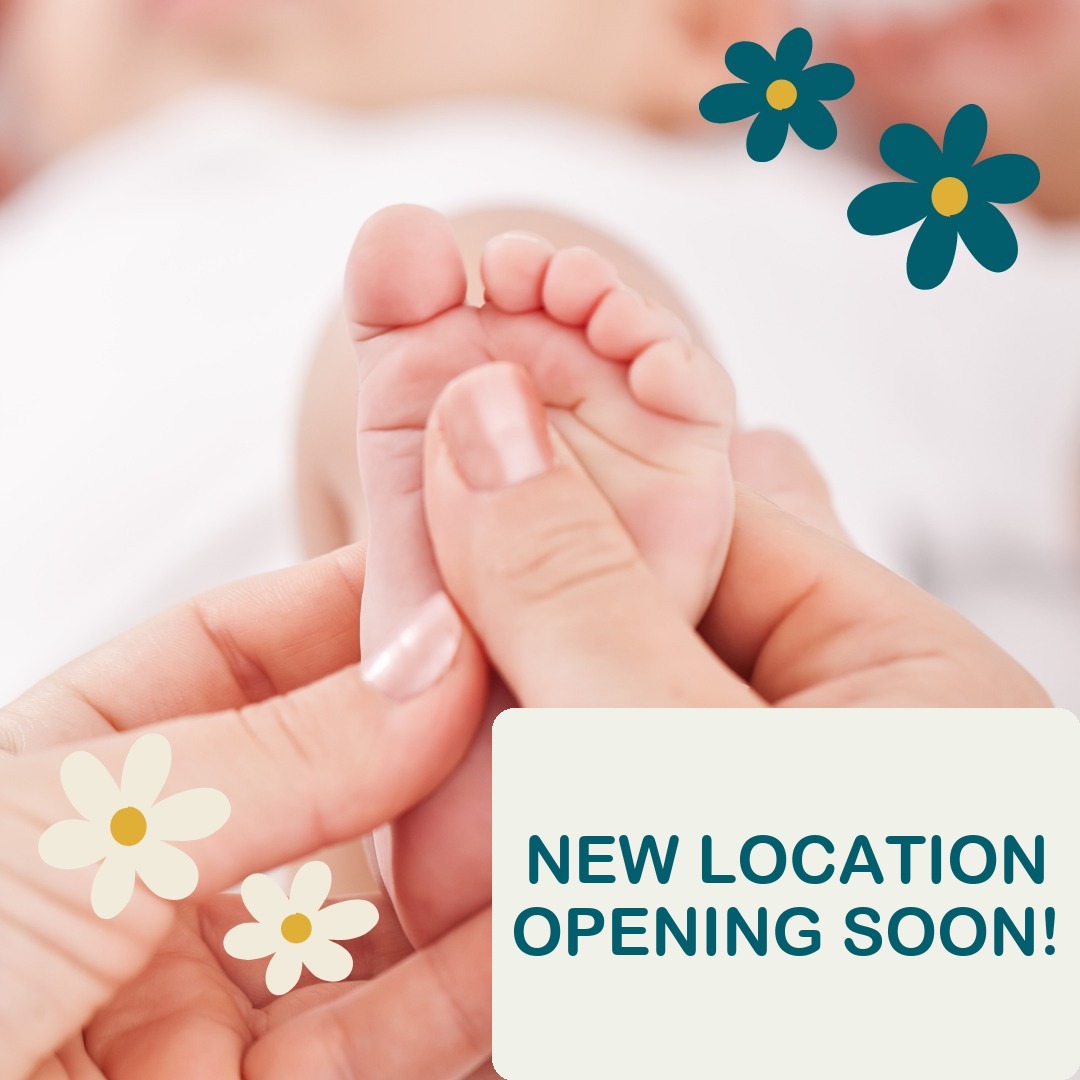 New location opening soon! Photo: hands gently supporting a baby’s foot.